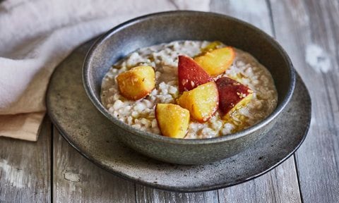 Vegan rice pudding made with oat milk and topped with peaches